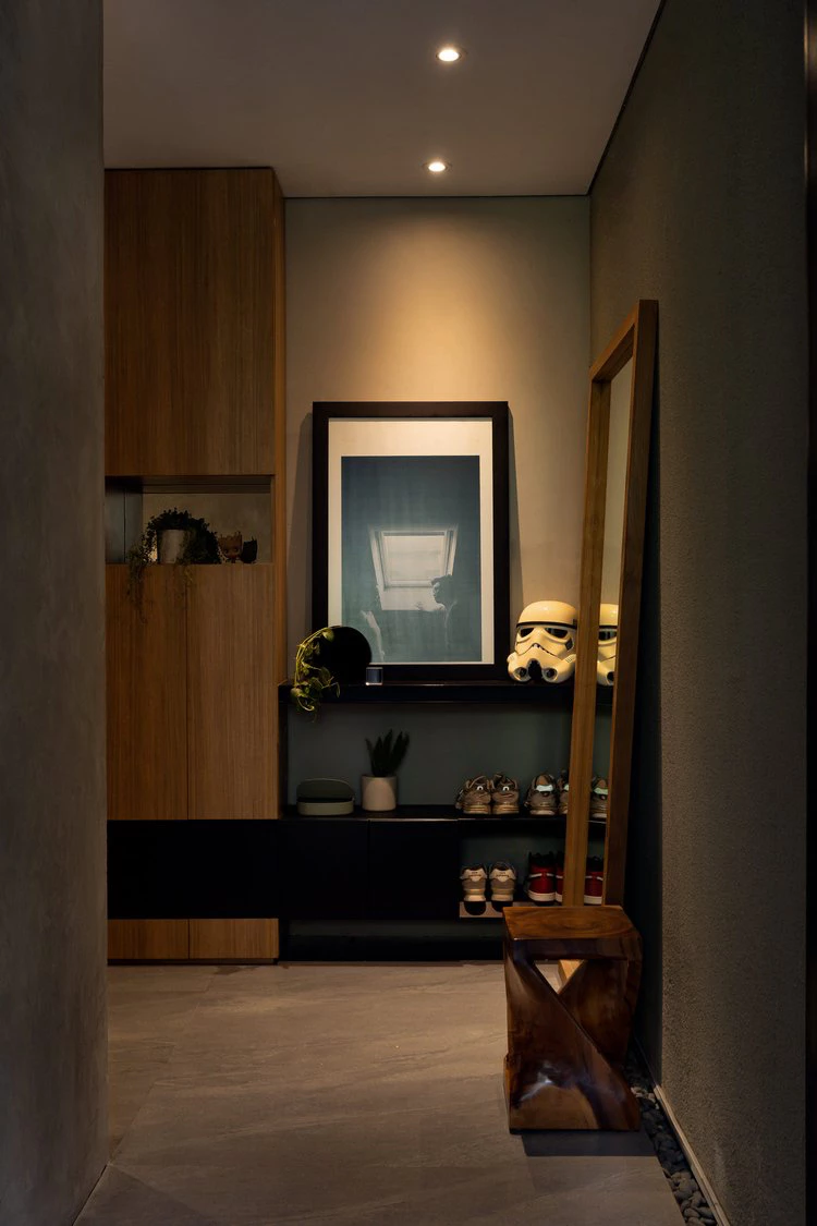 Moody entryway with framed art, mirror, and sneaker display